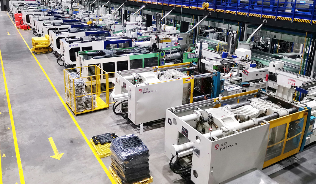 Rows of injection molding machines inside the Xinding production hall in Taizhou