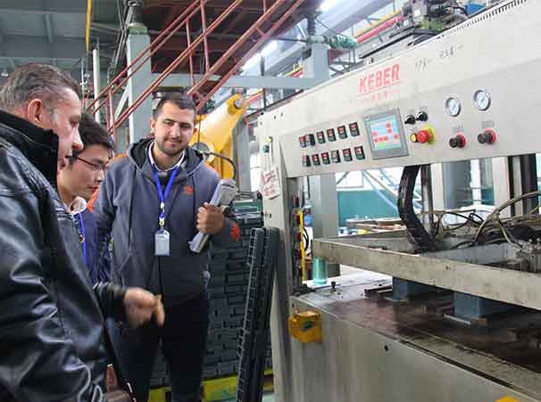 XDPC host presenting machinery specifications to overseas clients on a guided tour